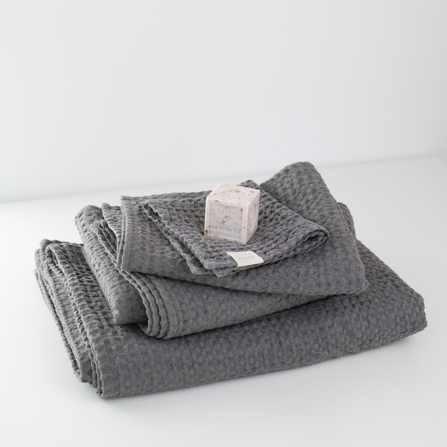 https://linentales.us/cdn/shop/products/DarkGreyHoneycombWaffleTowels.jpg?v=1647966449